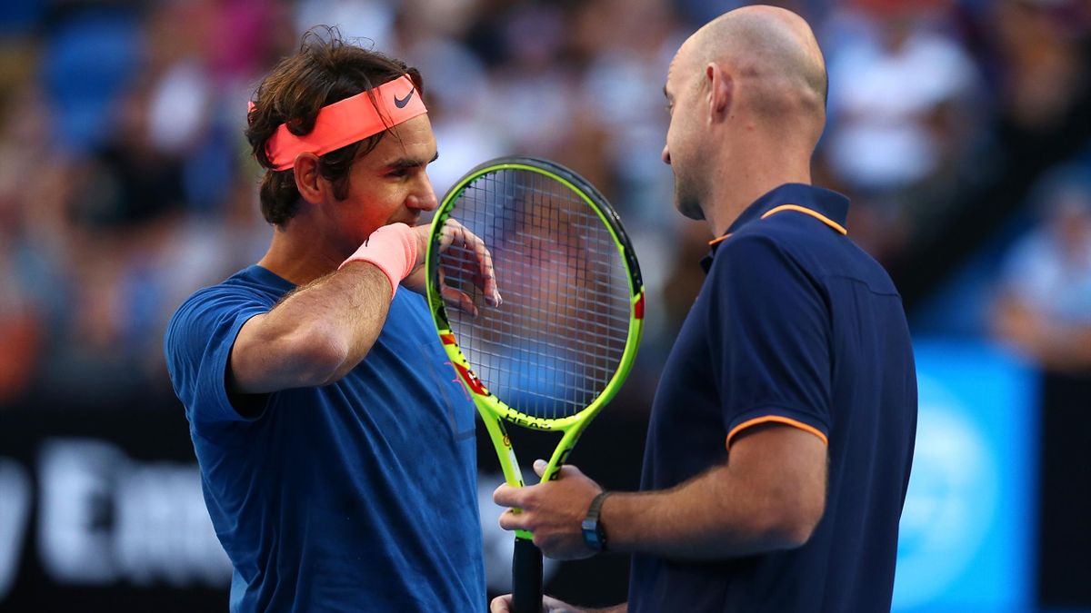 Roger Federer, one of the greatest tennis players of all time, listening intently to his coach.